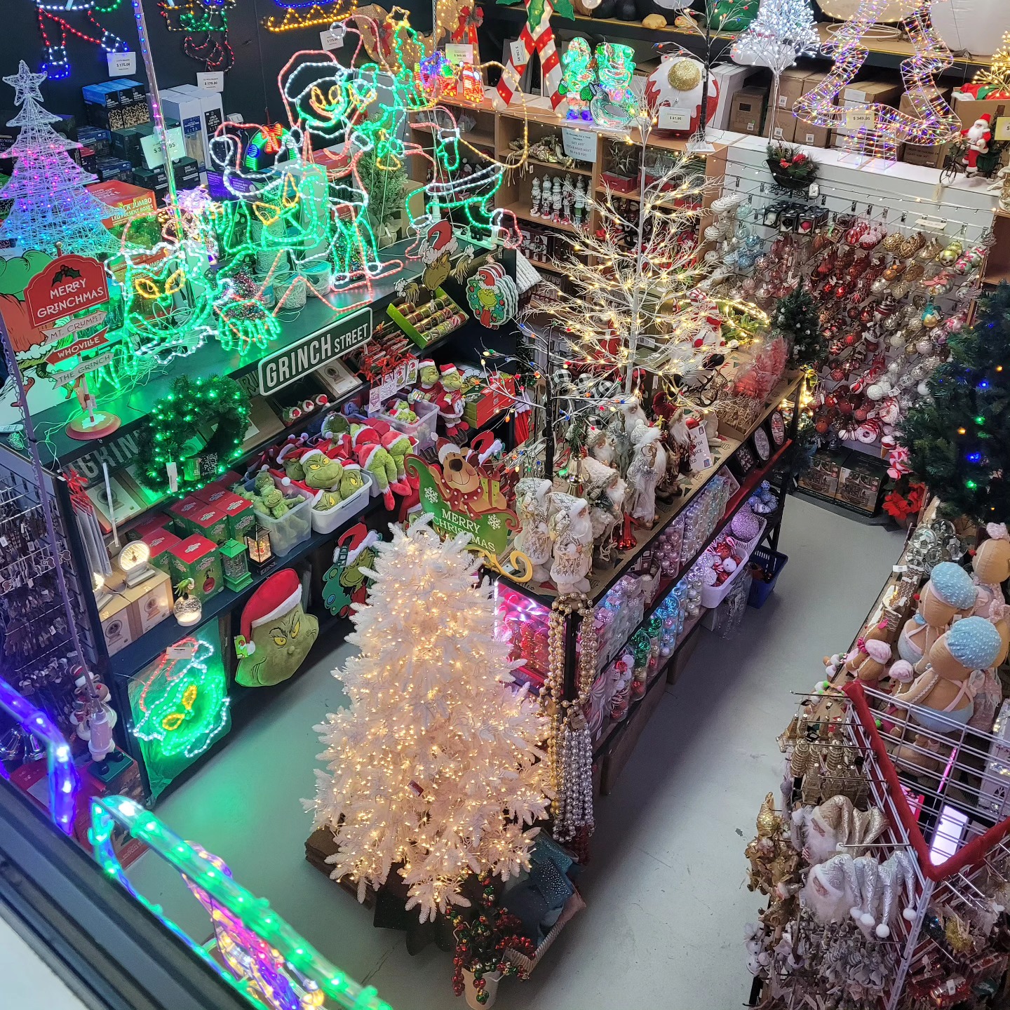 Inside the Dom's Christmas Shed showroom in Archerfield — lit trees, the Grinch range and decorations packed in tight